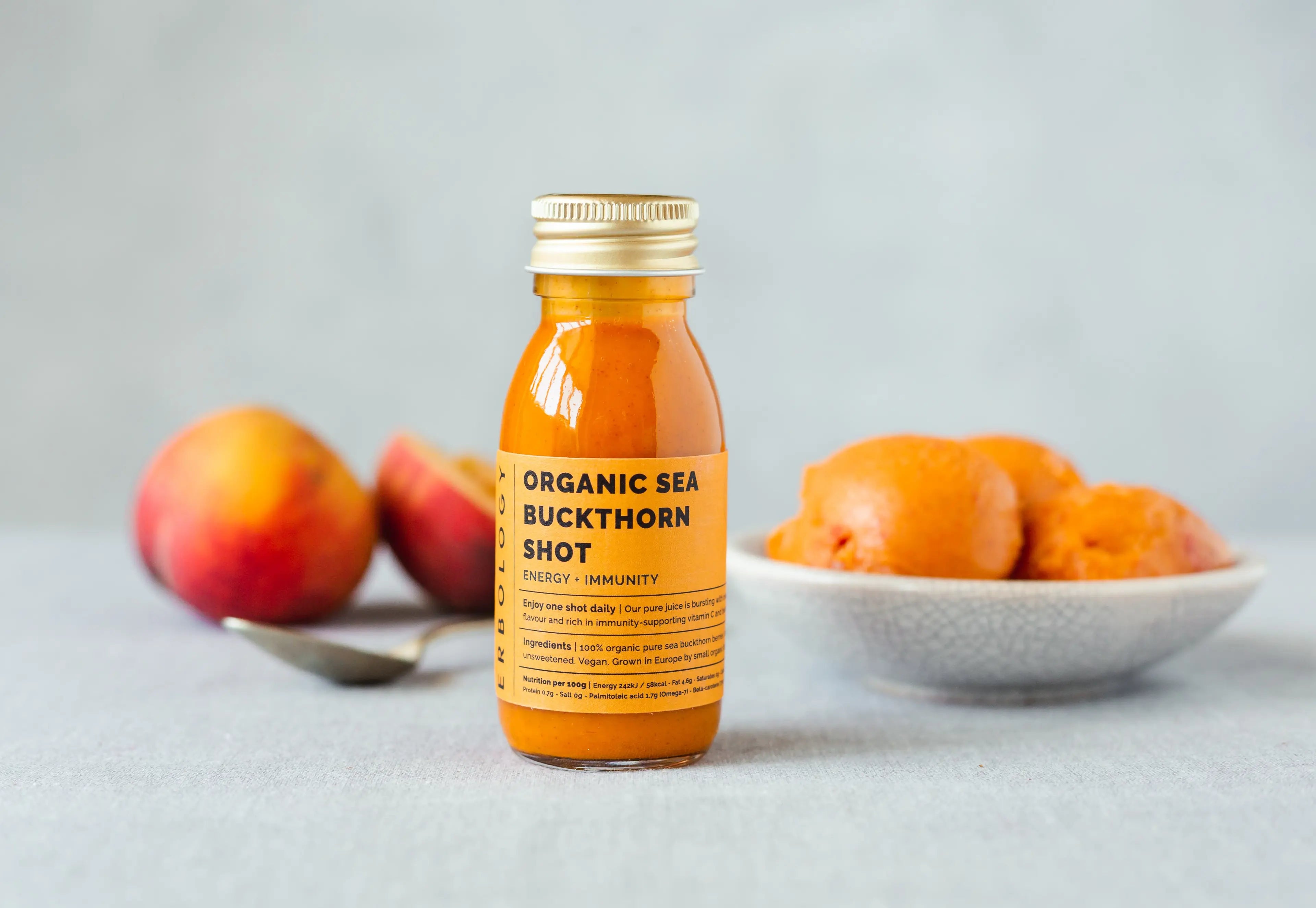 Erbology Organic Sea Buckthorn Shot bottle close-up, highlighting natural, undiluted juice rich in vitamin C, omega-7, and vitamin A for immune support and eye health.
