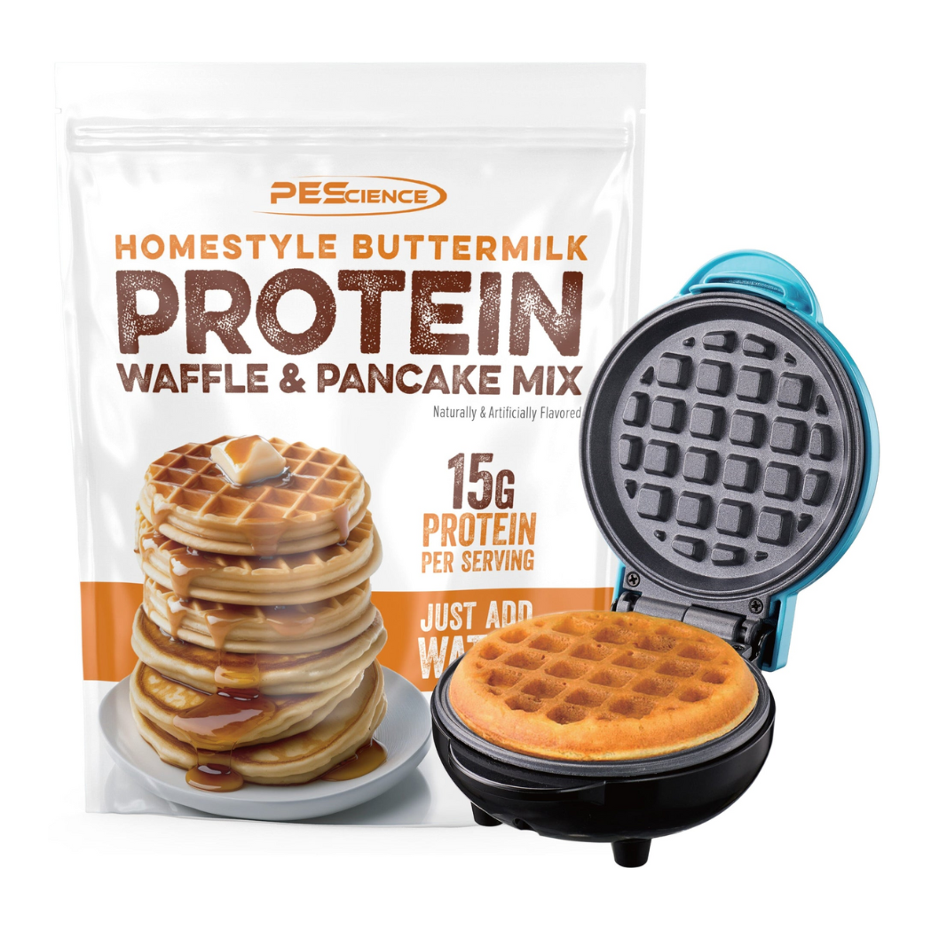 PE Science Protein Pancake & Waffle Mix next to a waffle maker and a stack of waffles, highlighting the protein-rich breakfast option.