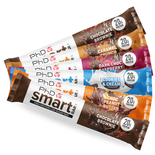 PhD Smart Bar packages showcasing protein-rich, low-sugar snacks with a dessert-like appearance, featuring caramel, protein crispies, and white chocolate.