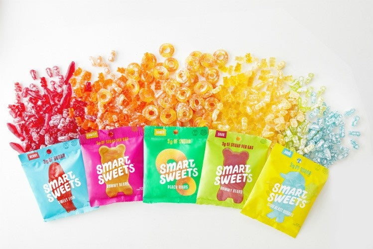 SmartSweets candy bag featuring non-GMO, sugar-free treats with natural flavors like raspberry, lemon, peach, and green apple, ideal for health-conscious fitness enthusiasts.