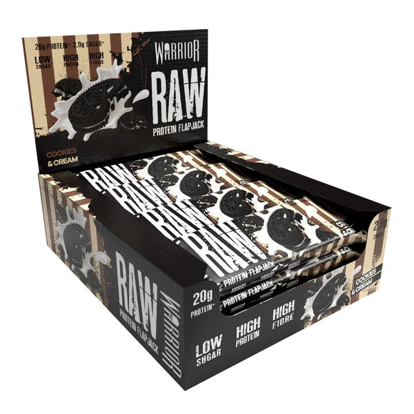 Warrior RAW Bar display box of Cookies & Cream protein flapjacks, each offering 20g protein, low sugar, high fibre, ideal for fitness enthusiasts.