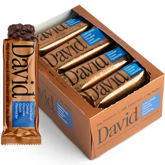 David's Crunch Bar retail box with individually wrapped bars and one partially unwrapped, showcasing a chocolate-coated, high-protein snack ideal for post-workout recovery.