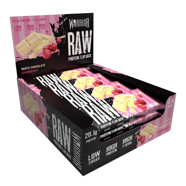 Warrior RAW Bar display featuring white-chocolate cranberry protein flapjacks, highlighting low-sugar, high-protein, and high-fiber content, ideal for fitness enthusiasts seeking nutritious on-the-go snacks.
